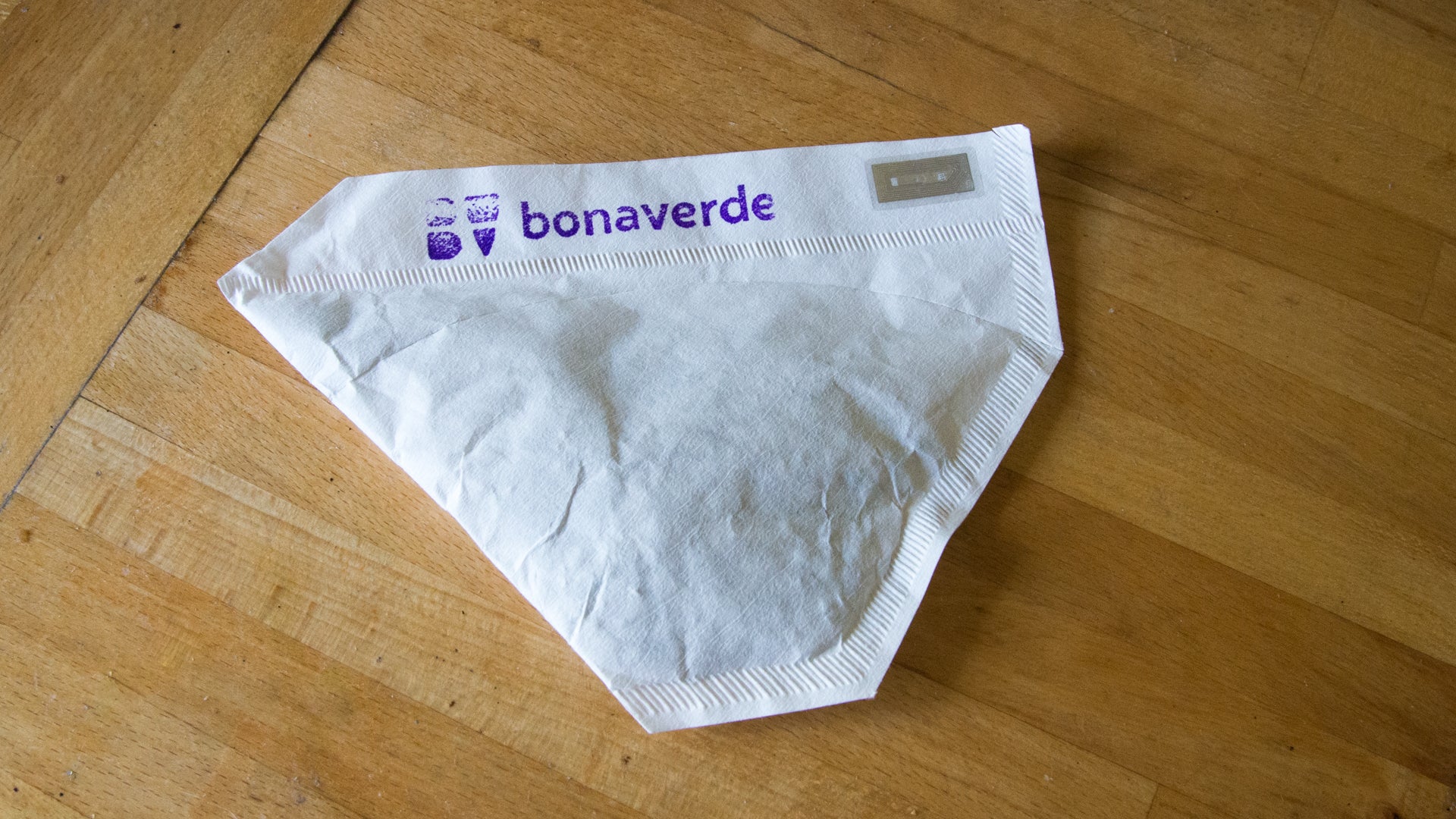 Bonaverde coffee machine filter pouch on wooden surface.