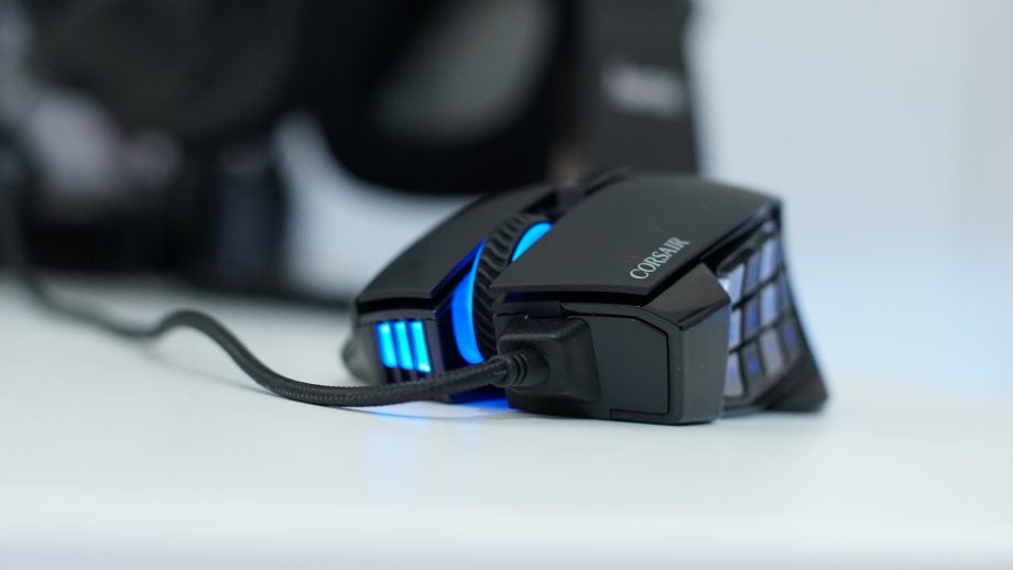 Corsair Scimitar Pro RGB gaming mouse on a white surface.
