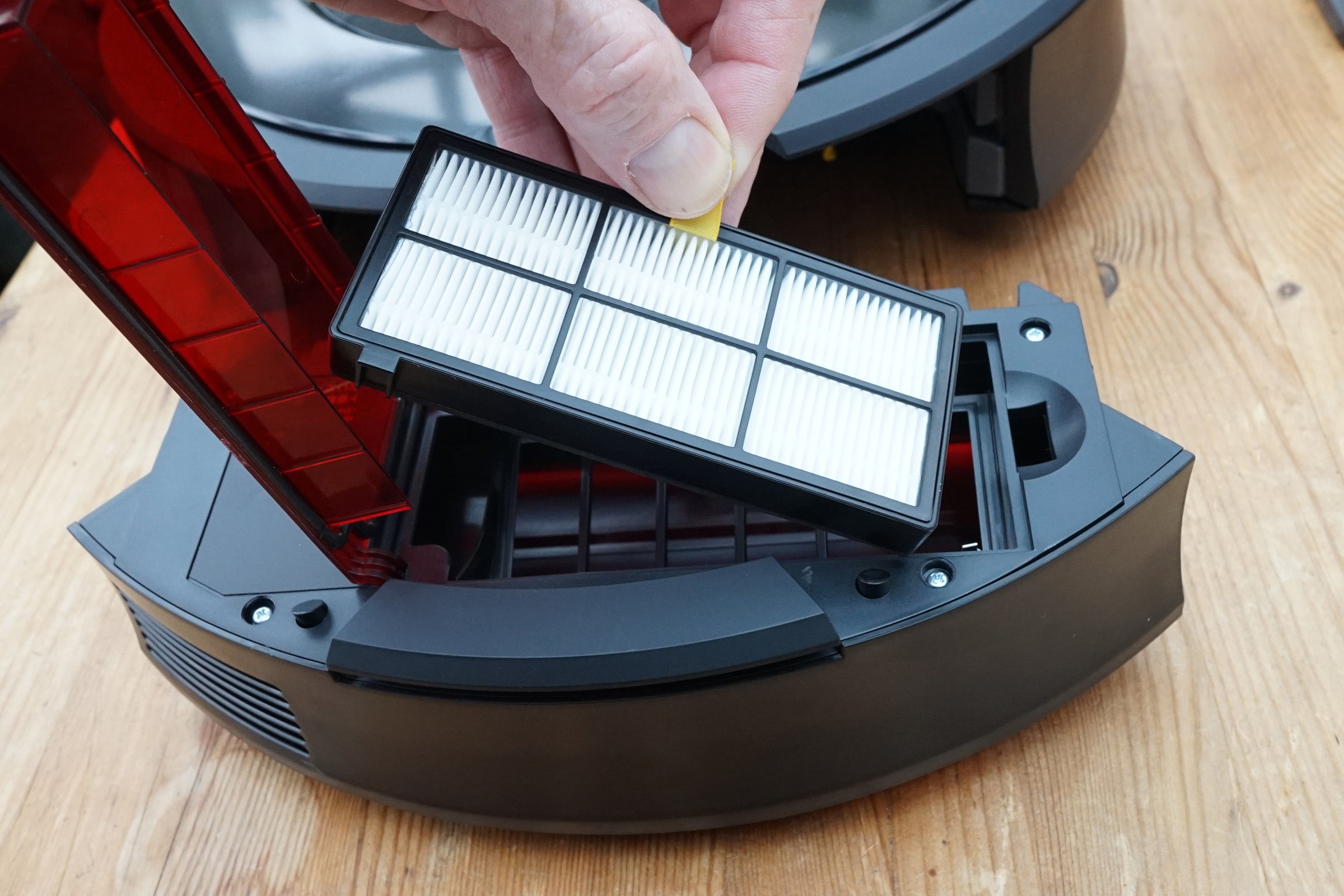 Changing the filter of an iRobot Roomba 875 vacuum.