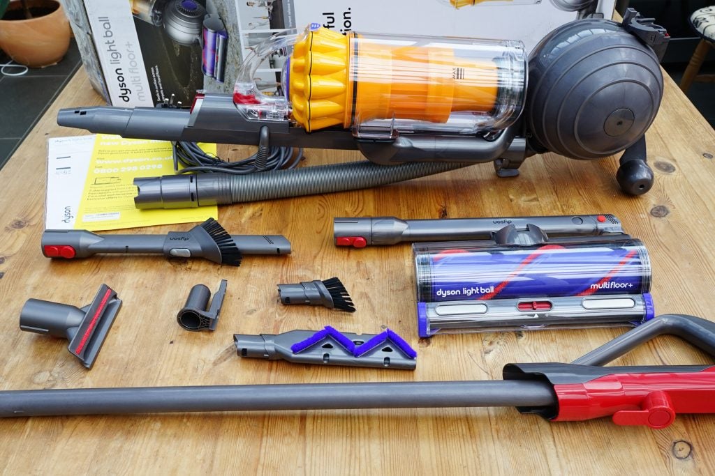 Dyson Light Ball Multi Floor vacuum and accessories displayed on table