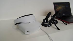 Dell Visor VR headset and motion controllers on table.