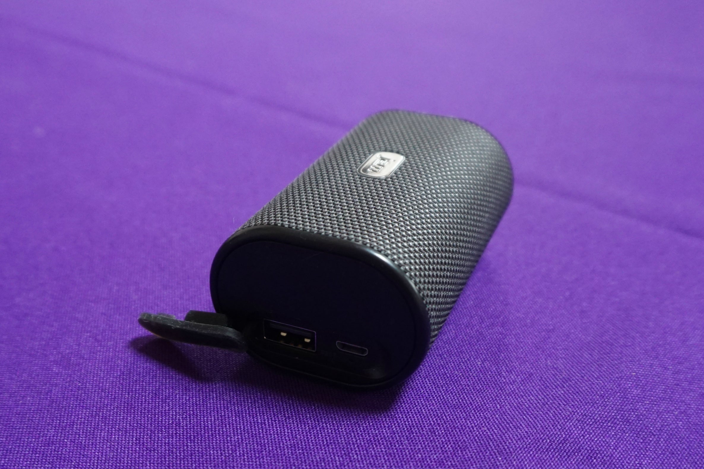 Black Jam Ultra wireless speaker on purple background