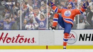 NHL 18 video game screenshot with celebrating hockey player.