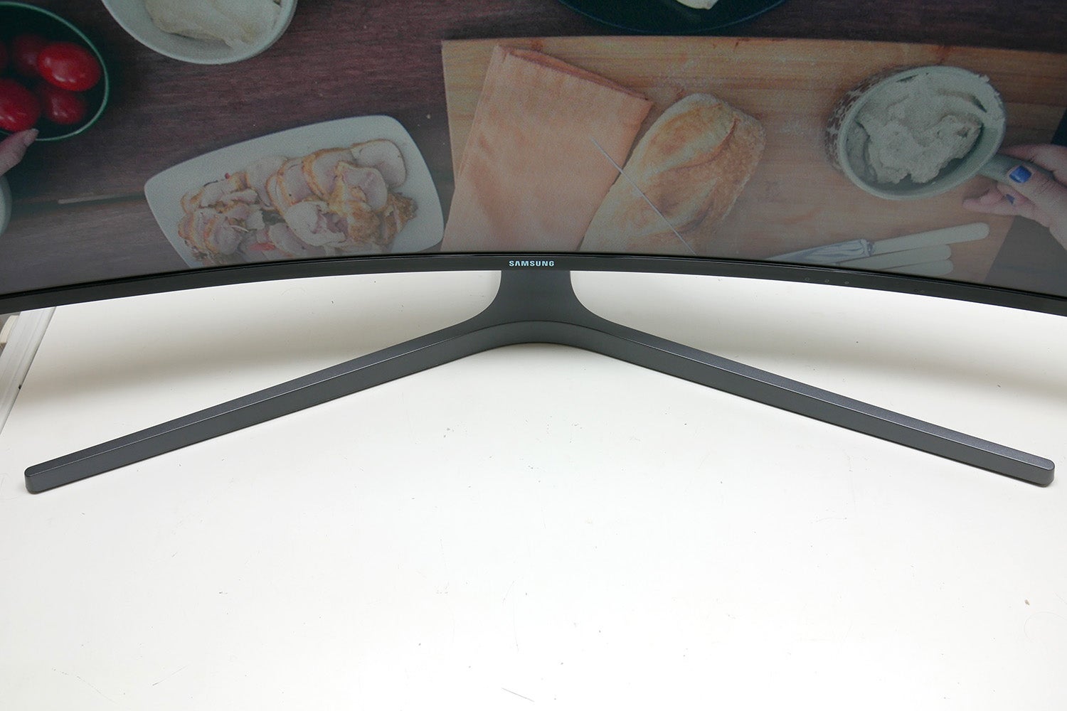 Samsung CHG90 curved monitor on desk displaying content.