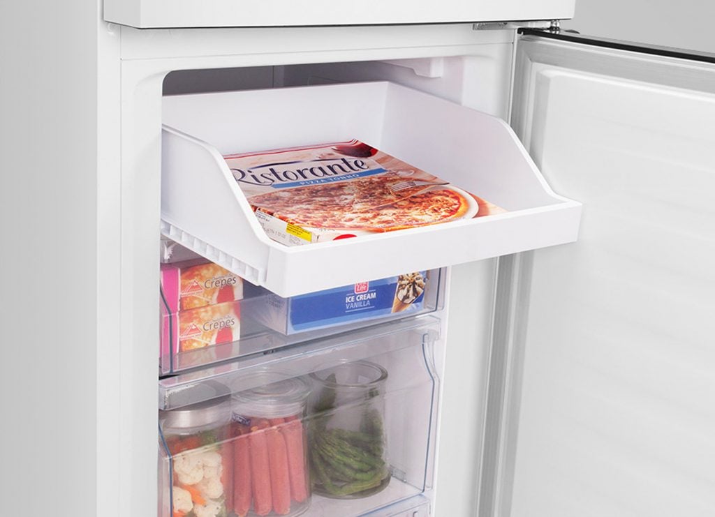 Hisense refrigerator interior with frozen pizza and drawers.