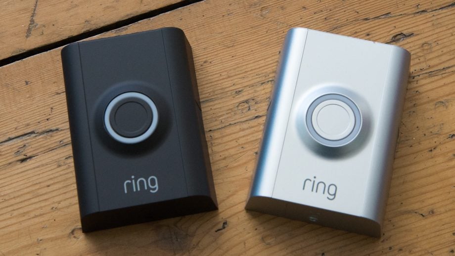 Two Ring Video Doorbell 2 devices on a wooden surface.