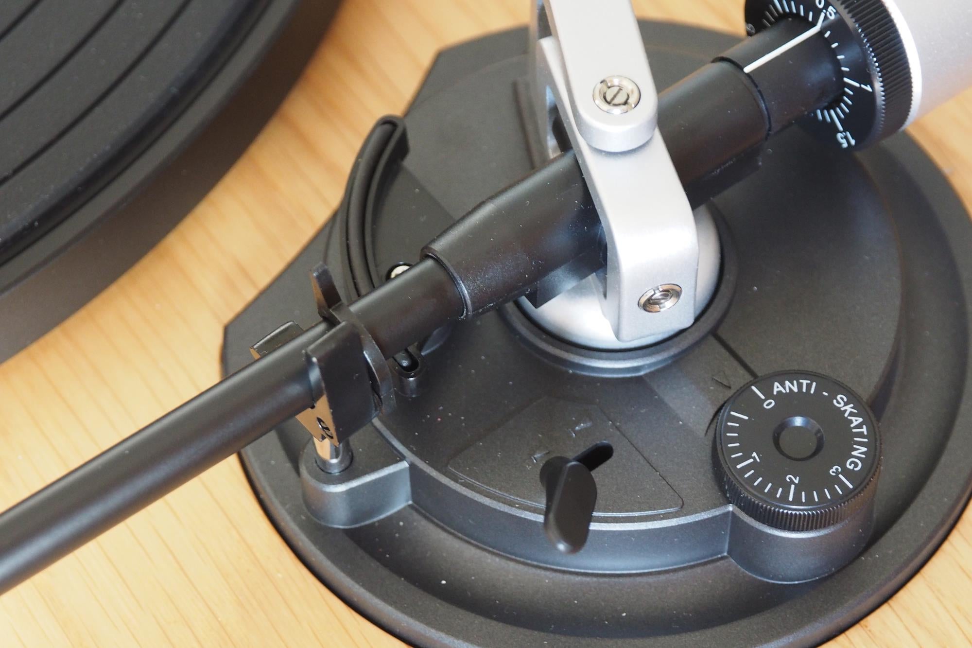 Close-up of a turntable tonearm and anti-skating control.