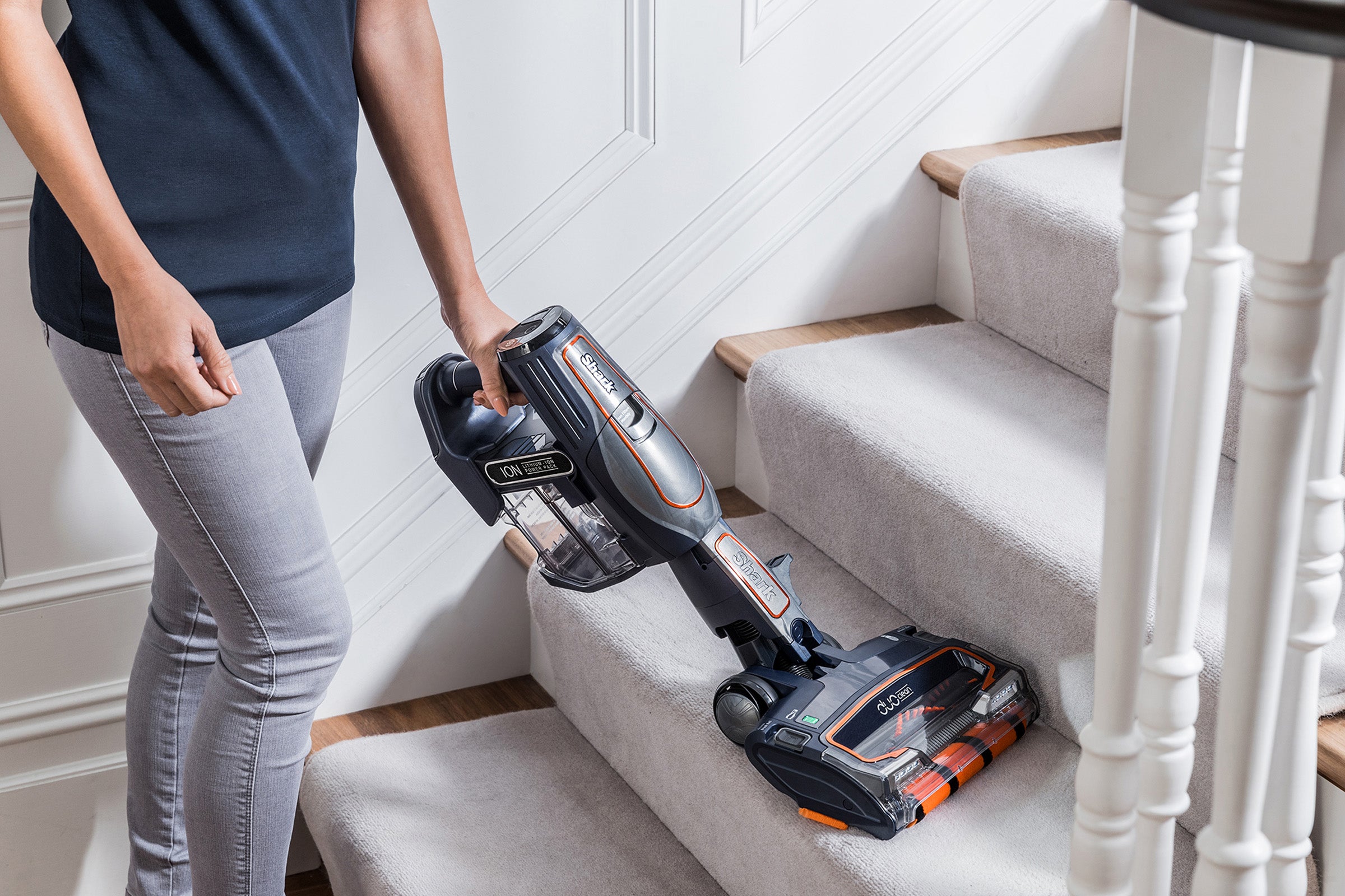 Shark DuoClean Cordless Vacuum used on staircase by person.