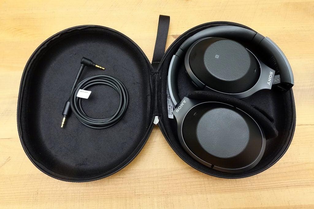 Sony WH-1000XM2 headphones with carry case and cable.