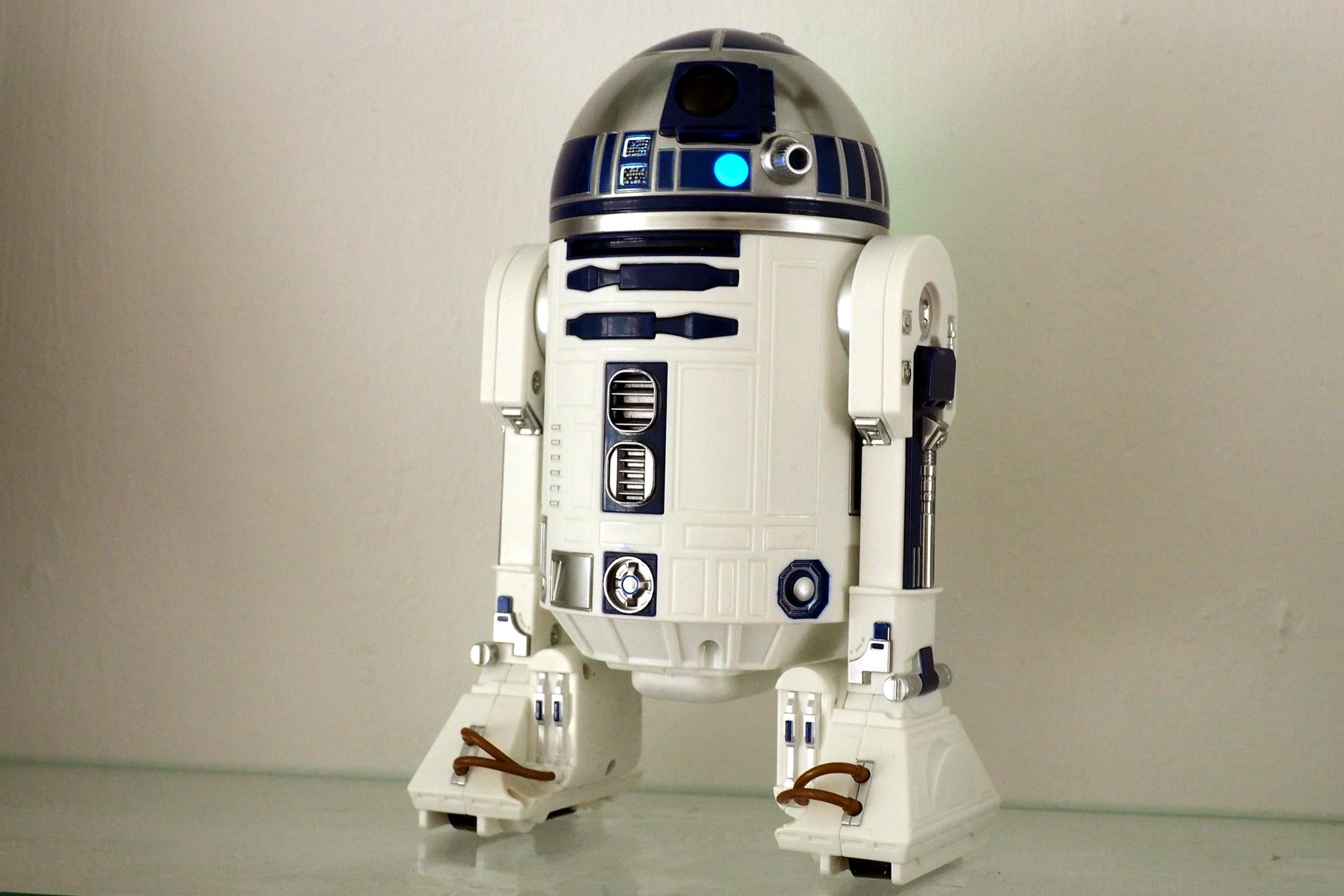 Sphero R2-D2 droid on white background with blue light on.