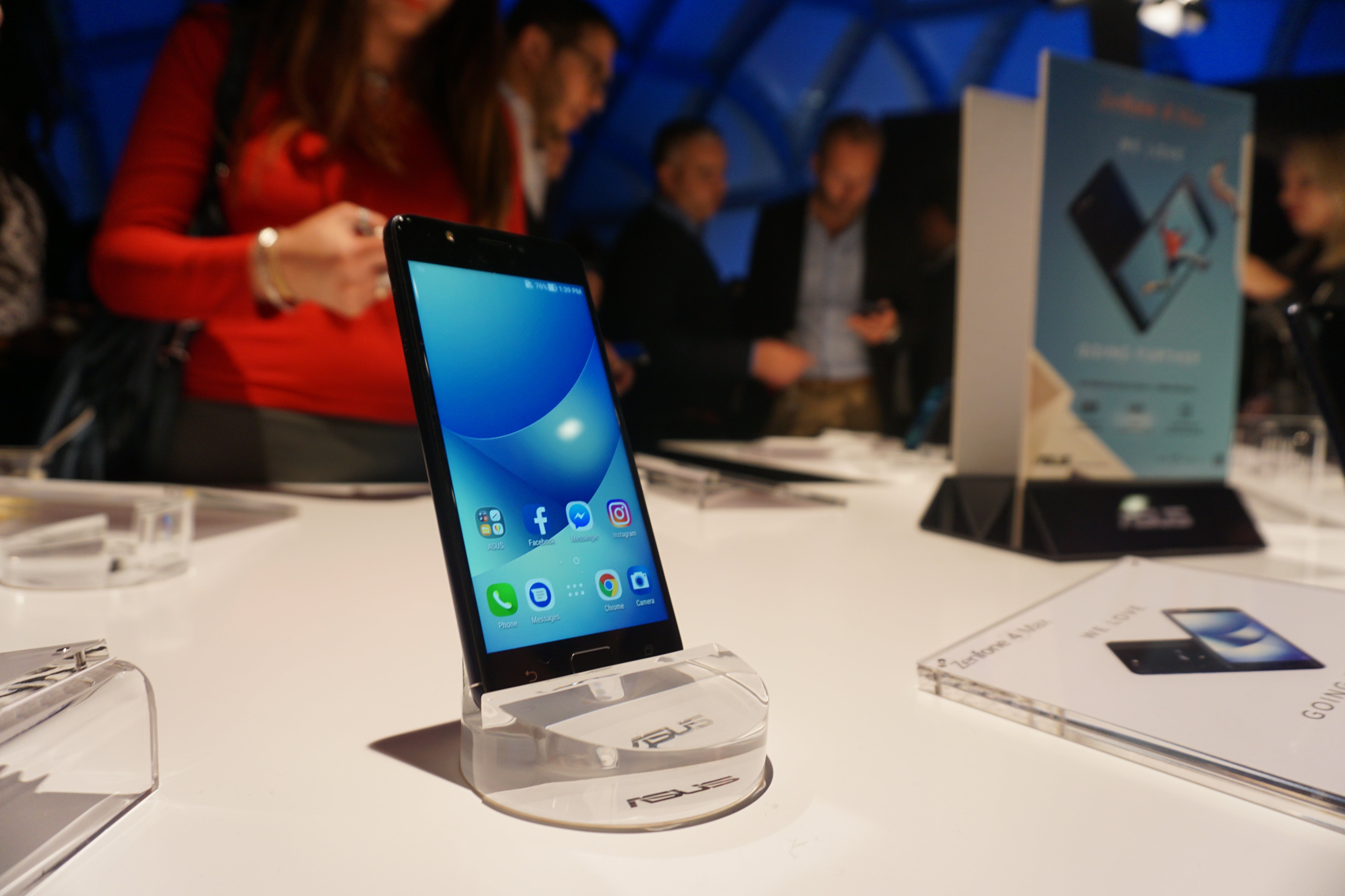 Asus Zenfone 4 Max displayed at an event with promotional materials.