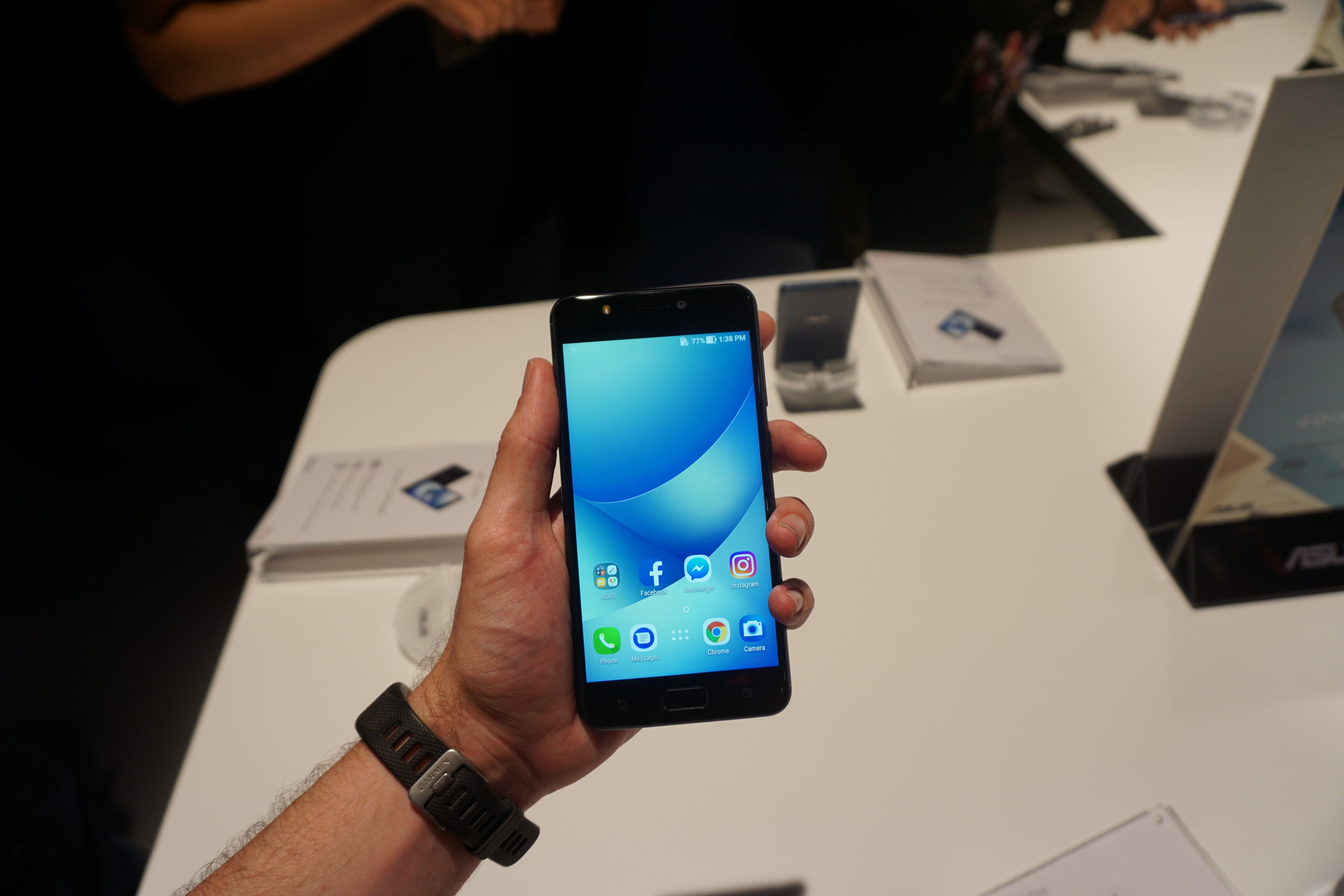 Hand holding Asus Zenfone 4 Max during a product demo.