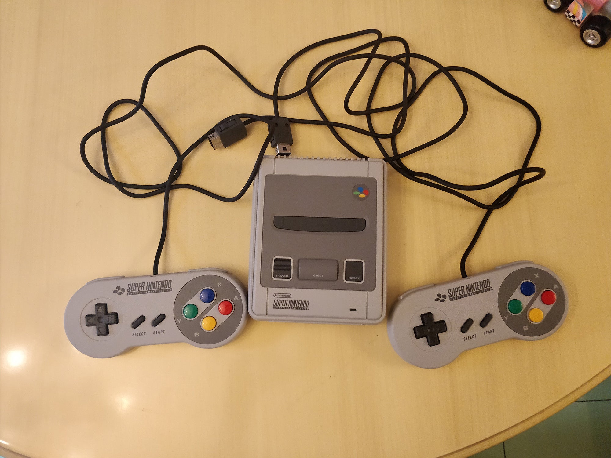 Nintendo Classic Mini SNES console with two controllers.