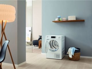Miele TDB120WP dryer in a modern laundry room.
