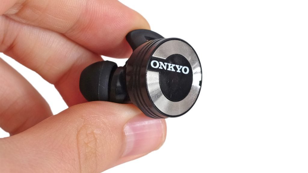 Onkyo W800BT wireless earbud held between fingers