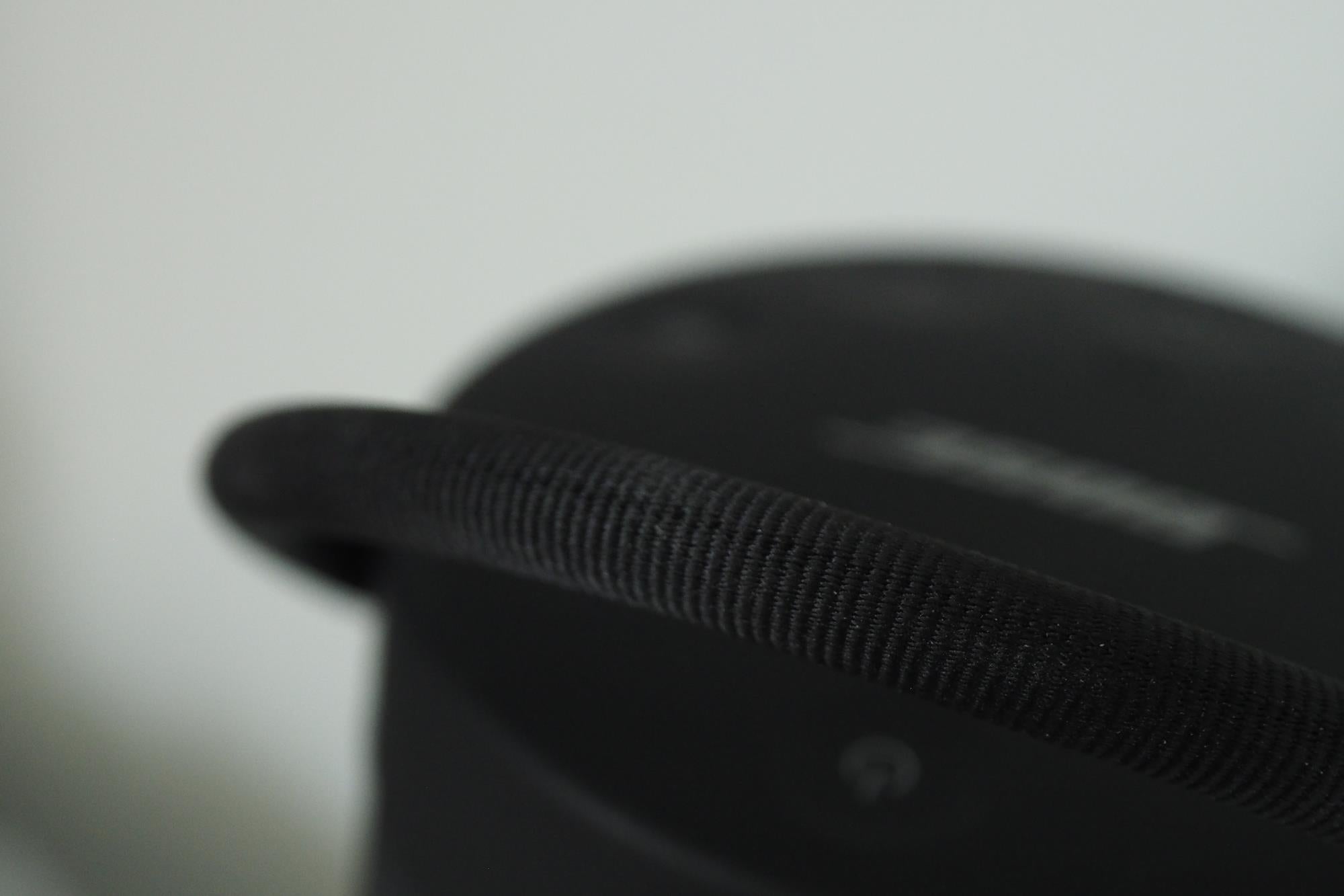Close-up of Bose SoundLink Revolve+ speaker handle detail.Bose SoundLink Revolve+ speaker next to vintage cameras.