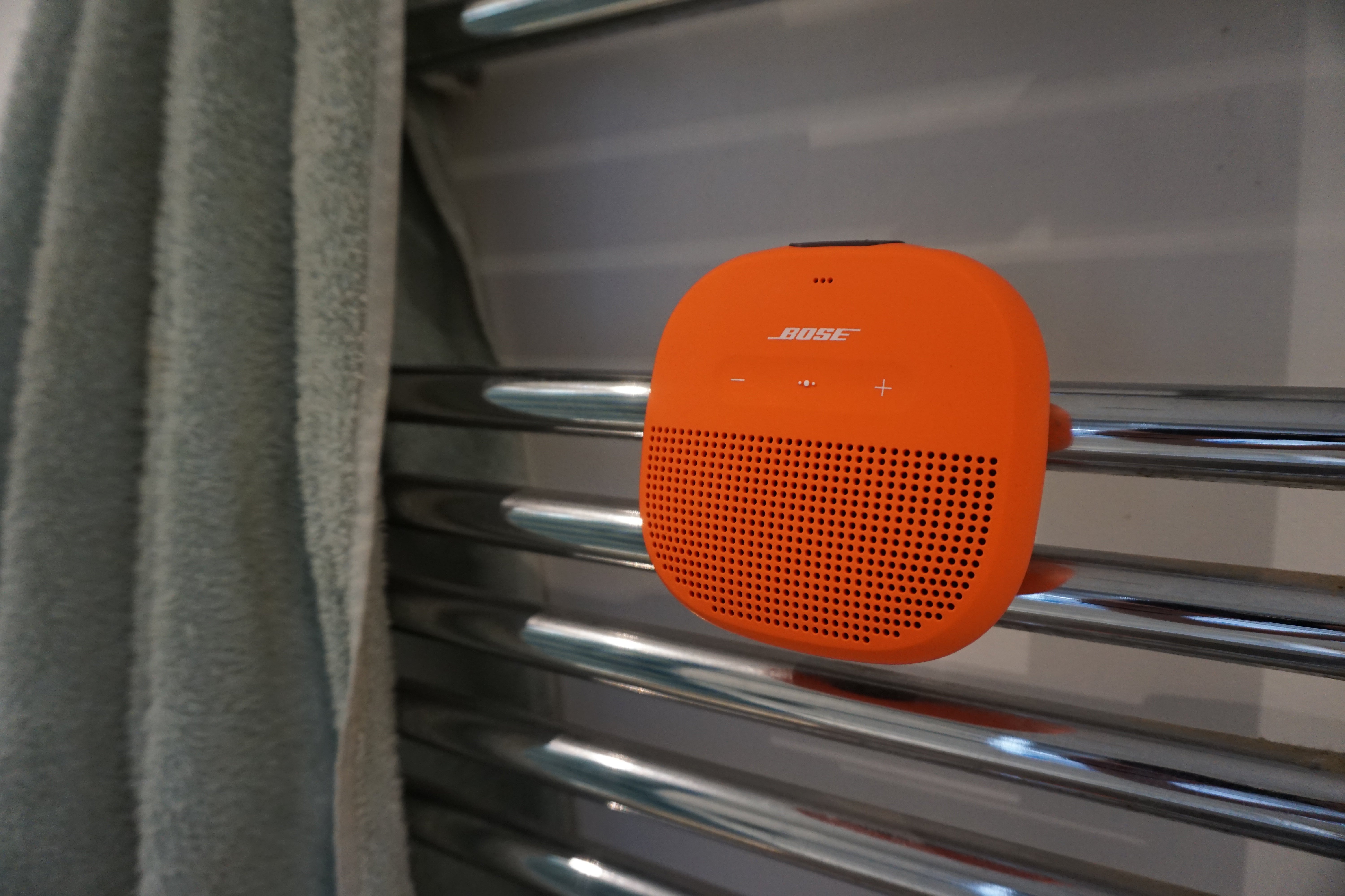 Bose SoundLink Micro speaker attached to metal rack.