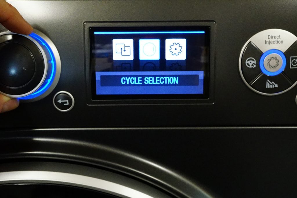 Close-up of washing machine control panel with cycle selection screen.