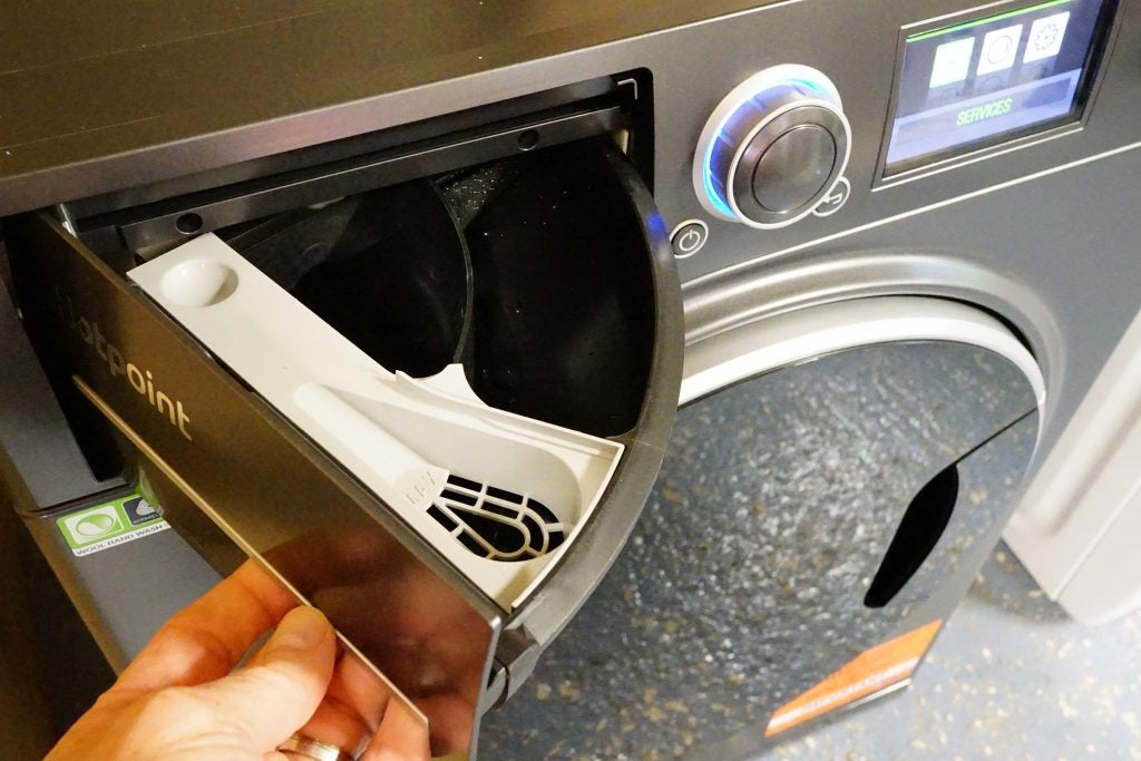 Close-up of Hotpoint washing machine detergent drawer being opened.