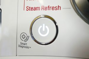 Close-up of LG washing machine power button and 