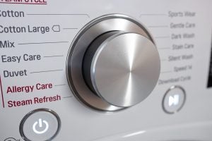 Close-up of LG washing machine control dial and program options.