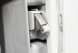 Close-up of Miele TDB120WP tumble dryer's door hinge.