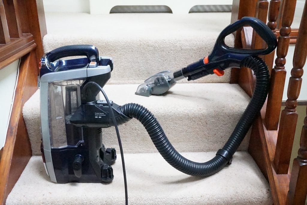 Shark DuoClean vacuum cleaner on carpeted stairs.