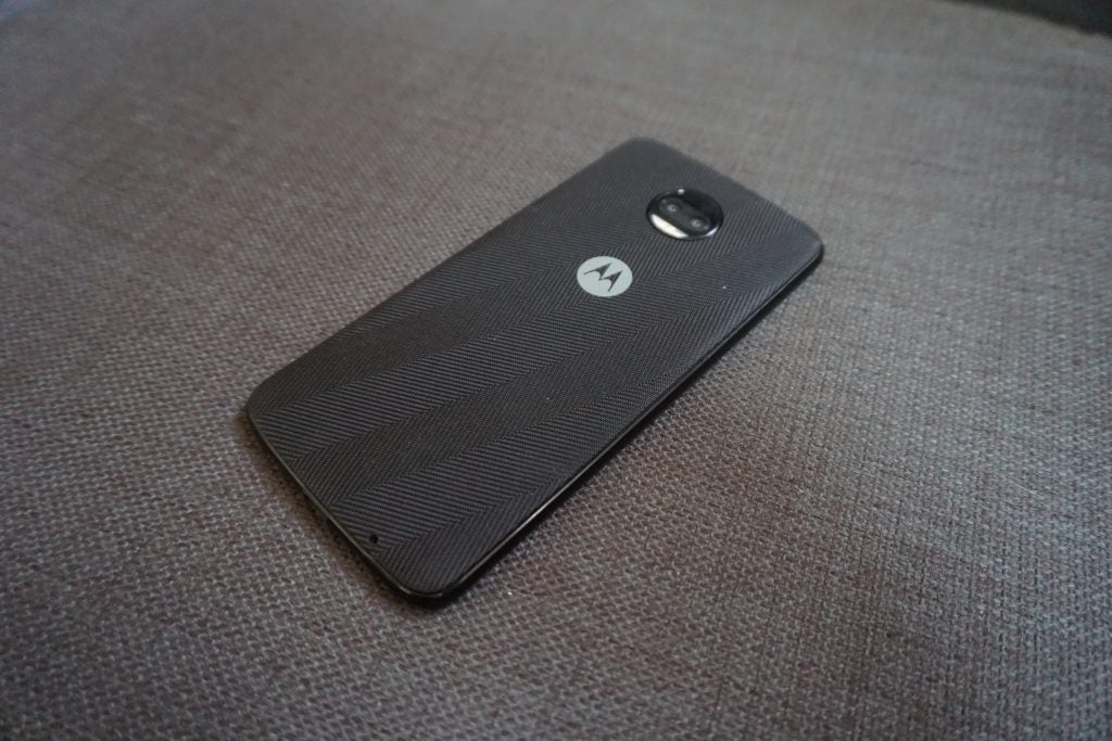 Moto Z2 Force smartphone with textured back lying on fabric.