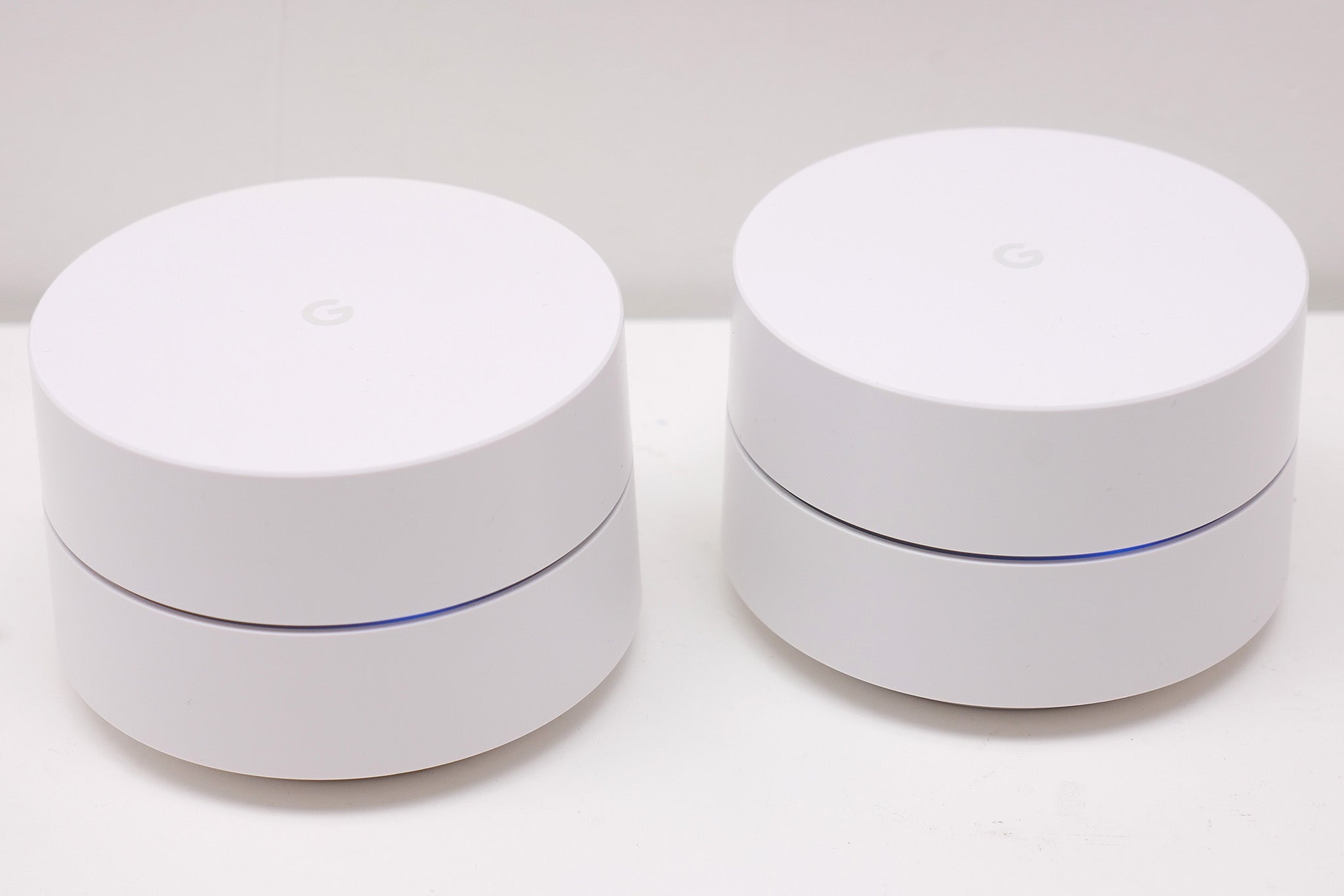 Two Google Wifi router units on a white background.