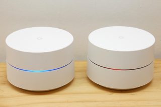 Two Google Wifi units with LED status indicators.