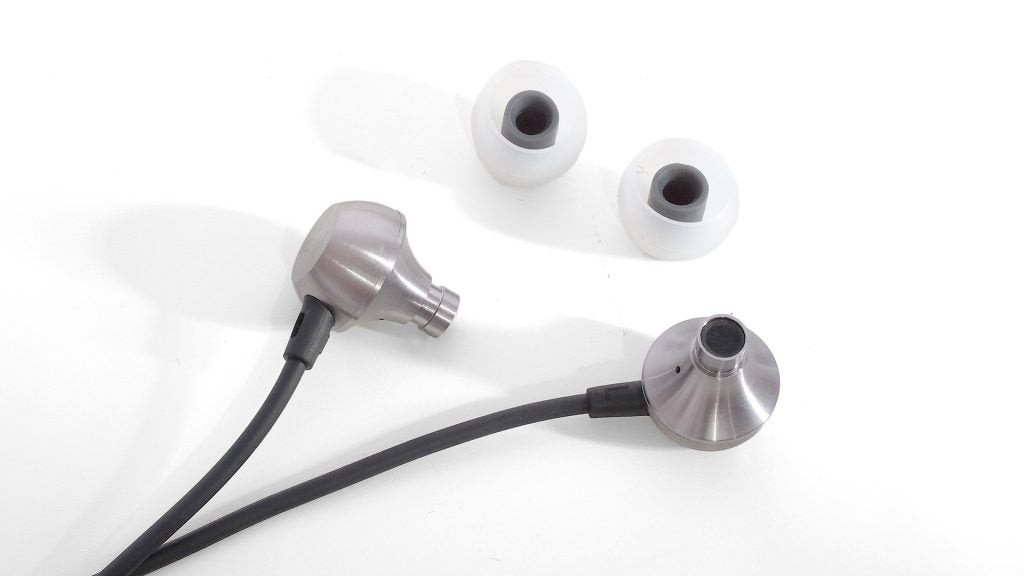 RHA MA650 wireless earbuds with extra ear tips.RHA MA650 wireless earbuds on pink background.