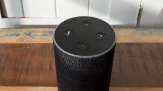 Amazon Echo smart speaker on wooden surface.