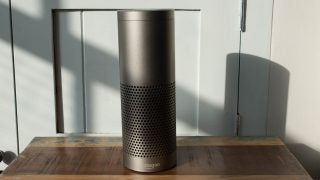 Amazon Echo Plus on wooden table with shadow.