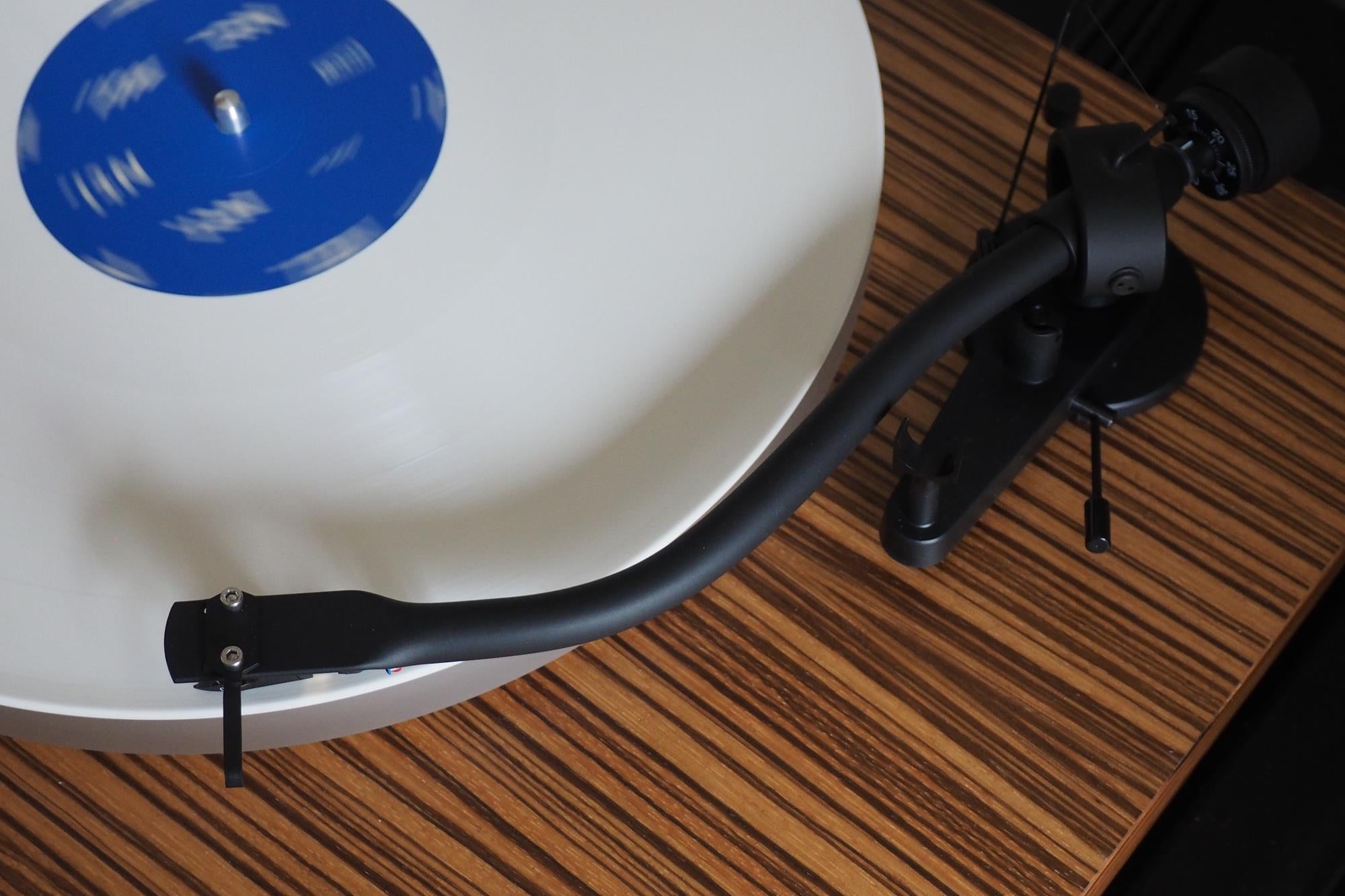 Crosley C20 turntable with white and blue vinyl record playing.