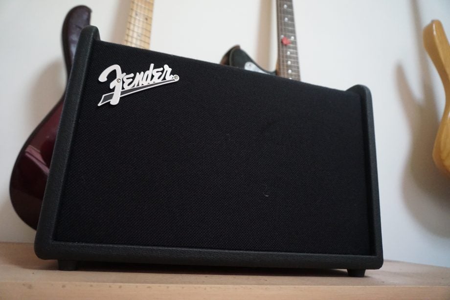 Fender Mustang GT 40 guitar amplifier with a guitar in background.