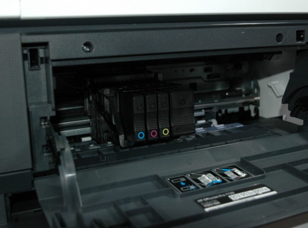 HP OfficeJet Pro 7720 printer showing ink cartridges.