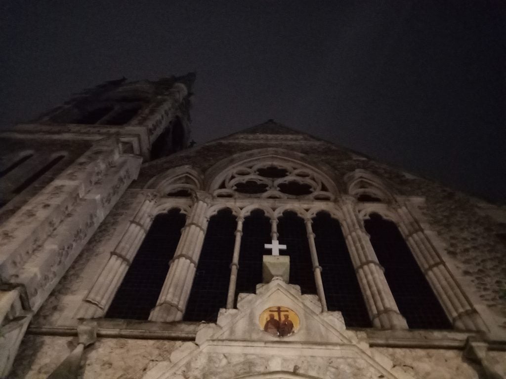 Low-light photo of a church's facade taken with camera.