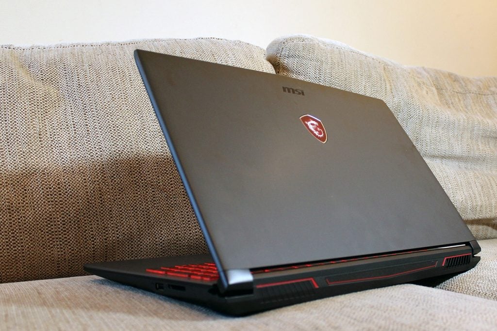 MSI GV62 7RC gaming laptop on a couch armrest.