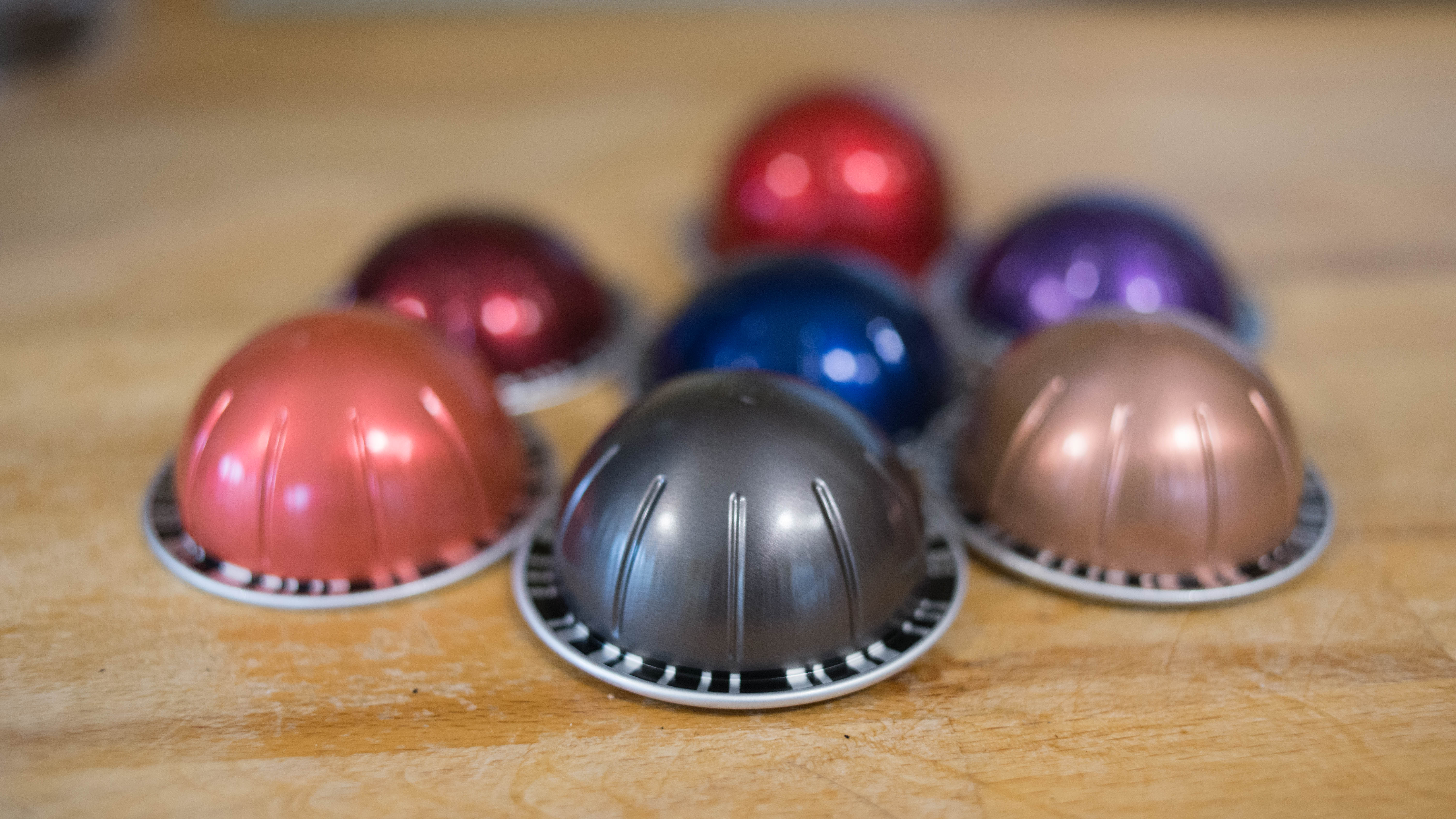 Assorted Nespresso Vertuo Plus coffee capsules on a table.