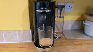Nespresso Vertuo Plus machine dispensing coffee into cup.