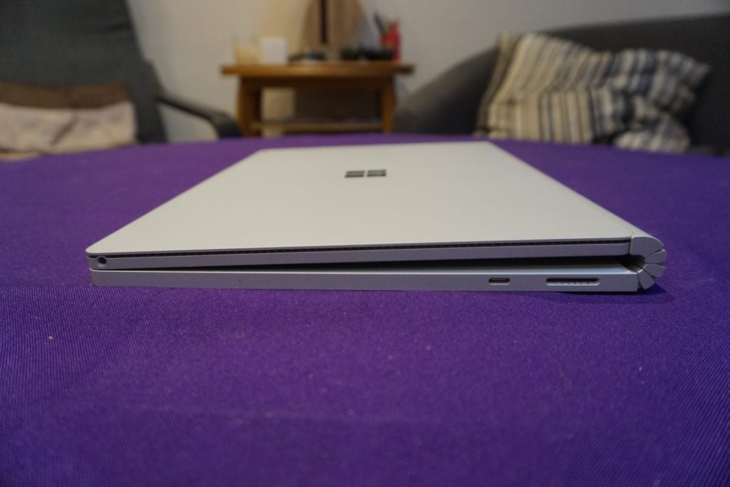 Surface Book 2 on table with colorful screen display.Surface Book 2 closed on a purple surface.