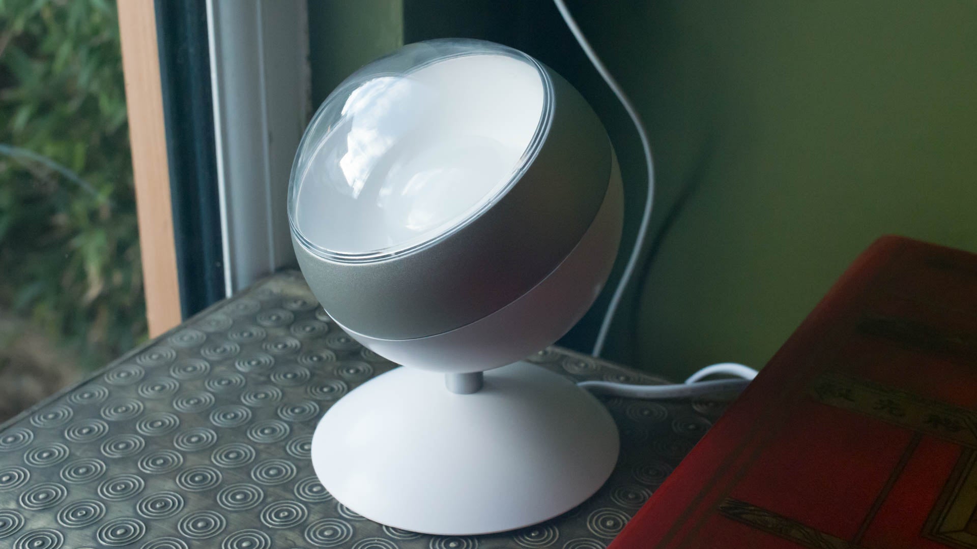 WiZ Connected smart lamp on a patterned tabletop.