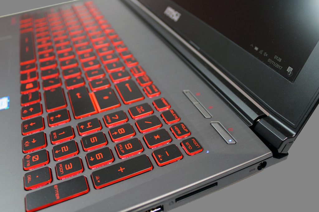 MSI GV62 7RC laptop with red-backlit keyboard and ports.