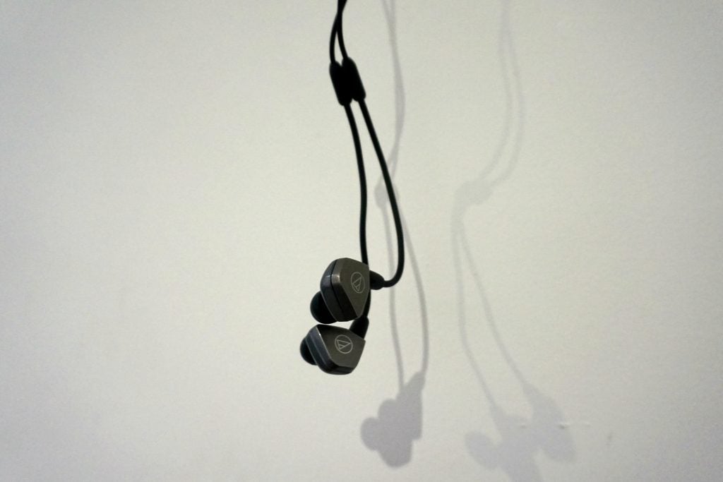 Audio-Technica ATH-LS70iS earphones with shadow on white background.
