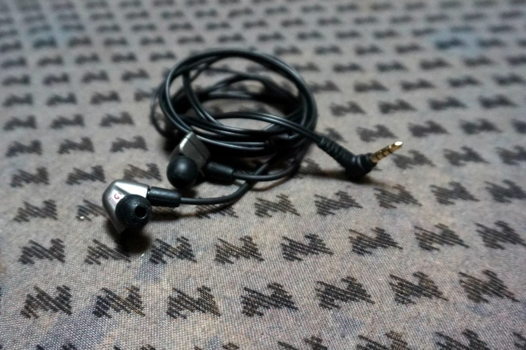 Audio-Technica ATH-LS70iS earphones on patterned fabric.