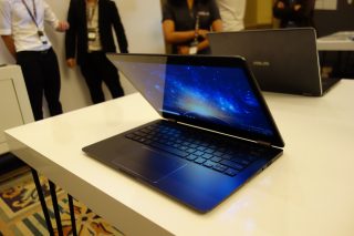 Asus NovaGo laptop on display with cosmic wallpaper.