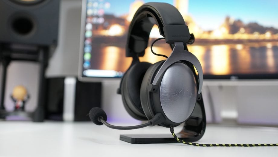 XTRFY H1 Pro Gaming Headset on desk with blurred background.