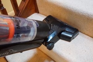 Hotpoint vacuum cleaner being used on carpeted stairs.