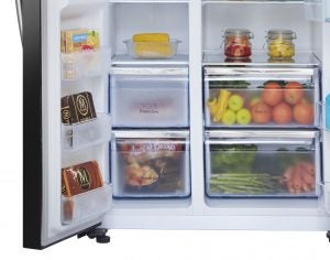 Hisense fridge-freezer interior stocked with food items.