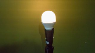 LIFX Mini Smart Bulb illuminated in a lamp holder.